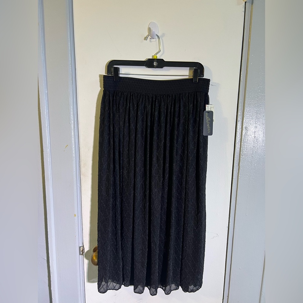 Soft black lined skirt 32” long with elastic waistband and lace textured overlay